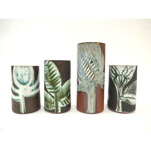 7085 - Four Briglin Pottery cylindrical vases, each with stylised foliate designs. Tallest 19.5cm