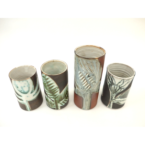 7085 - Four Briglin Pottery cylindrical vases, each with stylised foliate designs. Tallest 19.5cm