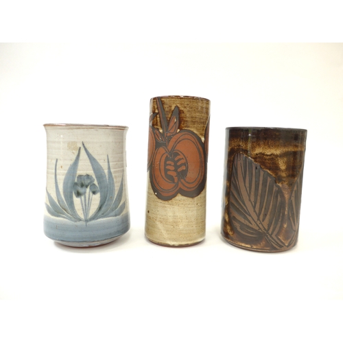 7099 - Three Briglin Pottery cylindrical vases, each with foliate designs, painted or etched. Tallest 19cm