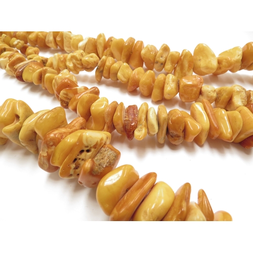 6097 - Two irregular shaped amber bead necklaces, 70cm and 80cm long approx, 308g total