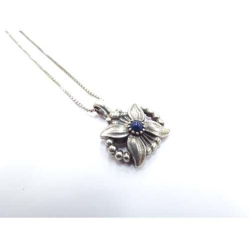 6412 - A Georg Jensen pendant of the year 1998 year pendant as an Edelweiss with central lapis lazuli caboc... 