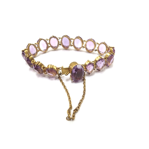 6421 - An amethyst coloured stone set gilt bracelet and four coloured glass drop necklaces (5)