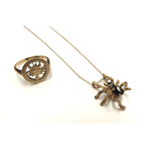 6100 - A 9ct gold spider pendant with sapphire body and head hung on a gold chain marked 9k, 40cm long and ... 