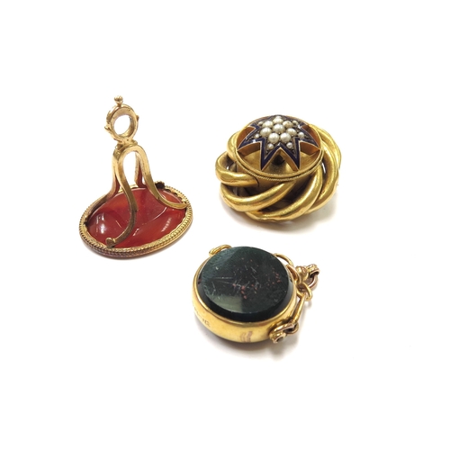 6131 - A carved cornelian intaglio fob in unmarked gold, a 9ct gold cornelian and bloodstone swivel fob and... 