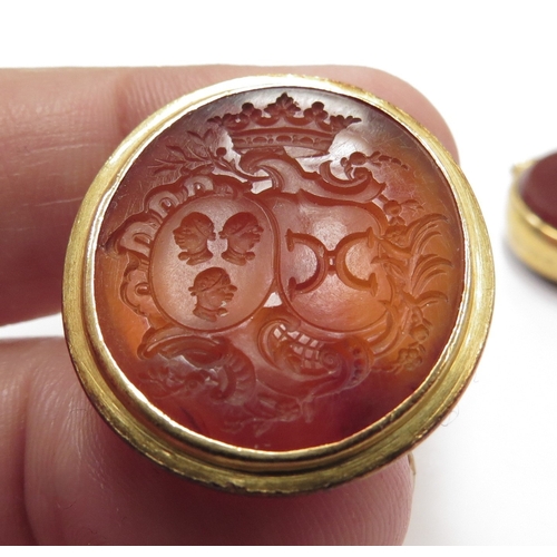 6131 - A carved cornelian intaglio fob in unmarked gold, a 9ct gold cornelian and bloodstone swivel fob and... 