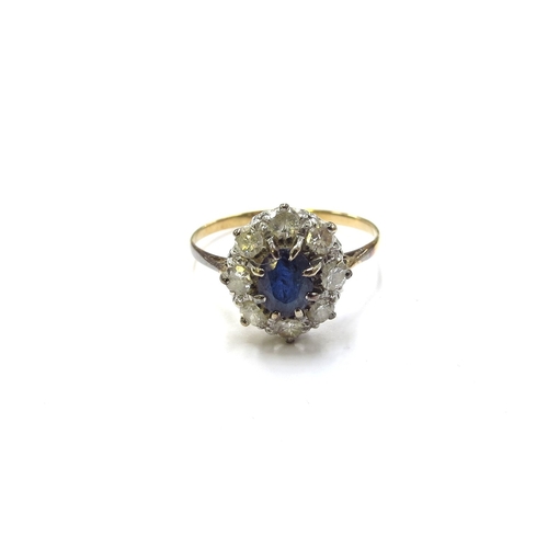 6133 - A sapphire and diamond cluster ring the central round cut sapphire framed by eight brilliant cut dia... 