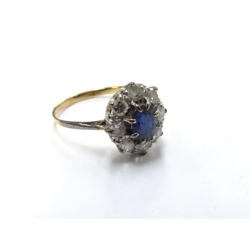 6133 - A sapphire and diamond cluster ring the central round cut sapphire framed by eight brilliant cut dia... 