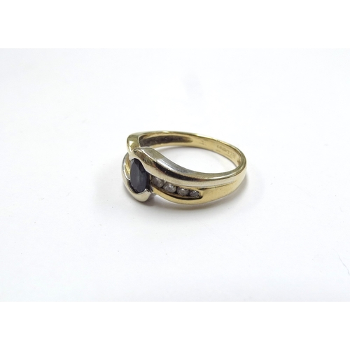 6380 - An 18ct gold sapphire and diamond crossover ring. Size J, 3.9g