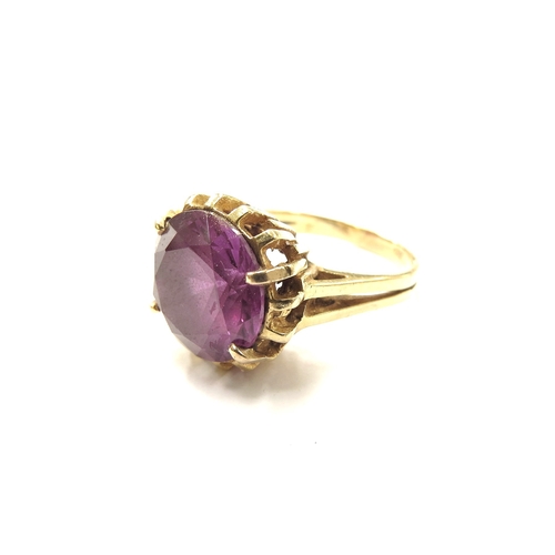 6232 - A yellow gold ring set with a large round cut amethyst, 12mm diameter, in four claw setting, marked ... 