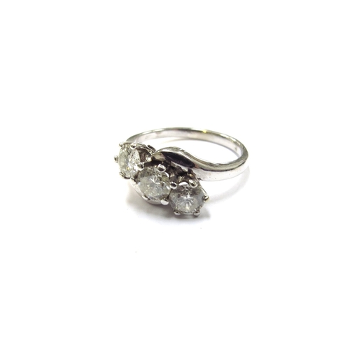 6124 - An 18ct white gold three stone crossover ring, 0.90ct total approx. Size J/K, 3.9g