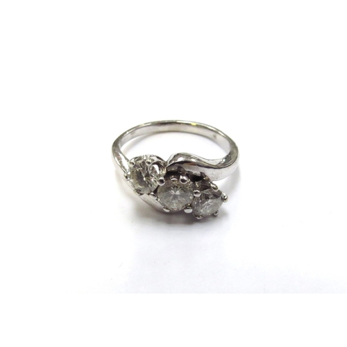 6124 - An 18ct white gold three stone crossover ring, 0.90ct total approx. Size J/K, 3.9g