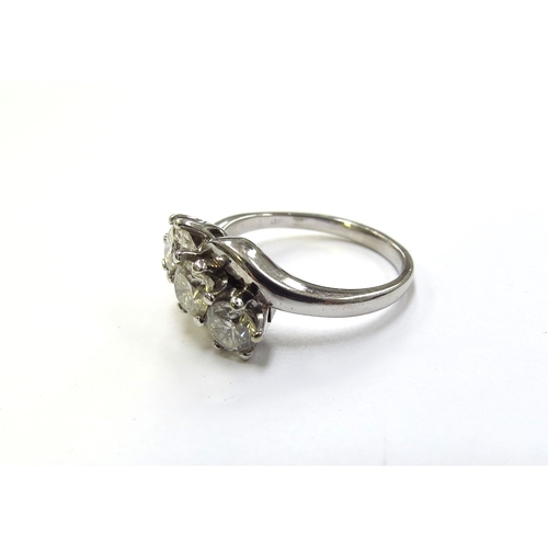 6124 - An 18ct white gold three stone crossover ring, 0.90ct total approx. Size J/K, 3.9g