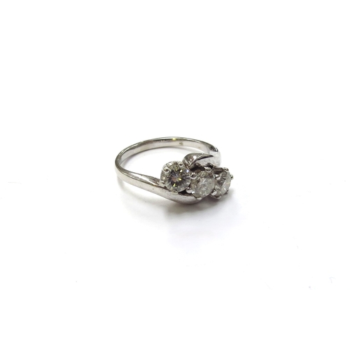 6124 - An 18ct white gold three stone crossover ring, 0.90ct total approx. Size J/K, 3.9g