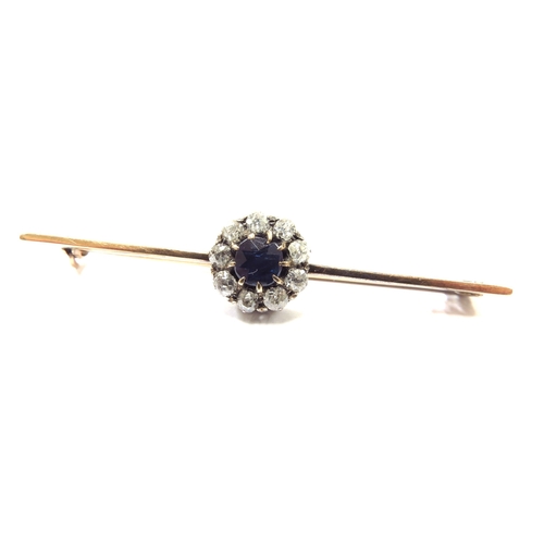 6153 - A sapphire and diamond cluster bar brooch the central sapphire framed by nine old cut diamonds, unma... 