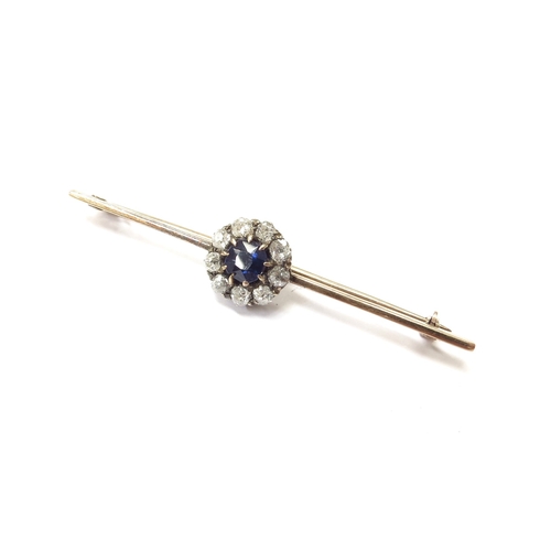 6153 - A sapphire and diamond cluster bar brooch the central sapphire framed by nine old cut diamonds, unma... 