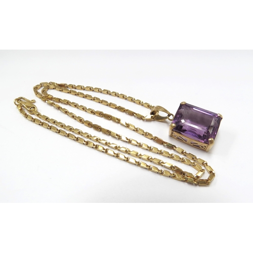 6117 - An amethyst pendant hung on a gold chain marked 98%, 44cm long, 10g (15.9g with pendant)