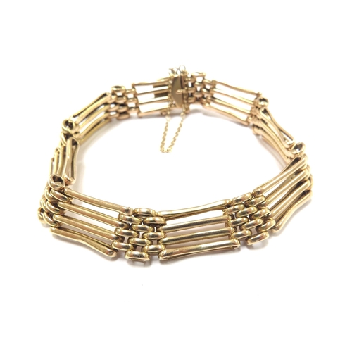 6057 - A gold gate bracelet, marked 15ct, 18cm long, 15.2g