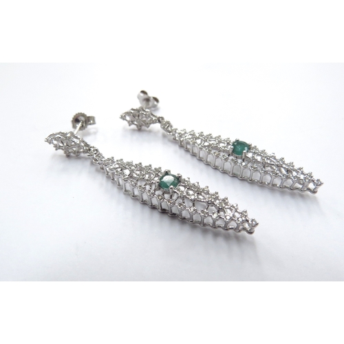 6167 - A pair of white gold diamond and emerald set wirework drop earrings, 5cm drop, 4.5g