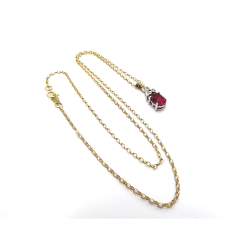 6107 - A ruby and diamond pendant hung on a 9ct gold chain, 45cm long, 3.6g