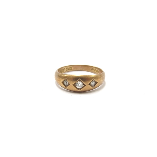 6253 - An 18ct gold three stone diamond gypsy ring. Size P, 4.5g