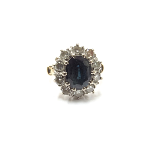 6060 - A sapphire and diamond cluster ring, the central sapphire 10mm x 7mm, framed by ten round cut diamon... 