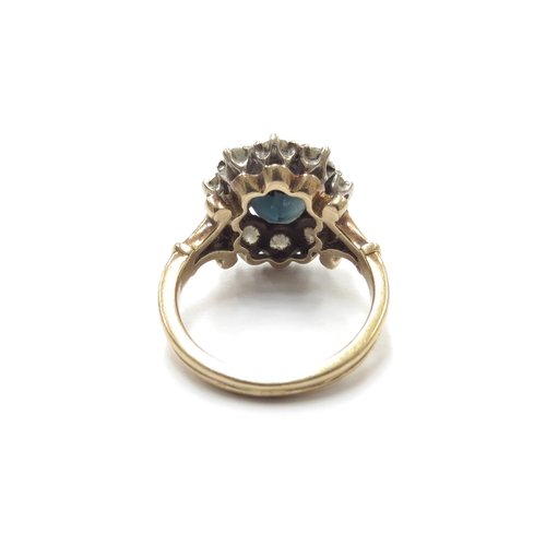 6060 - A sapphire and diamond cluster ring, the central sapphire 10mm x 7mm, framed by ten round cut diamon... 