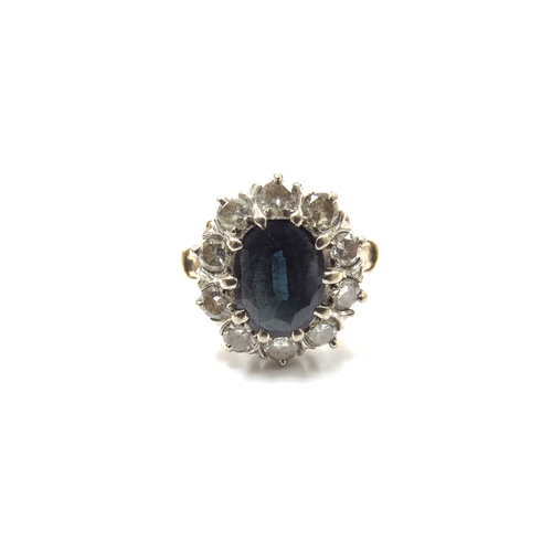 6060 - A sapphire and diamond cluster ring, the central sapphire 10mm x 7mm, framed by ten round cut diamon... 