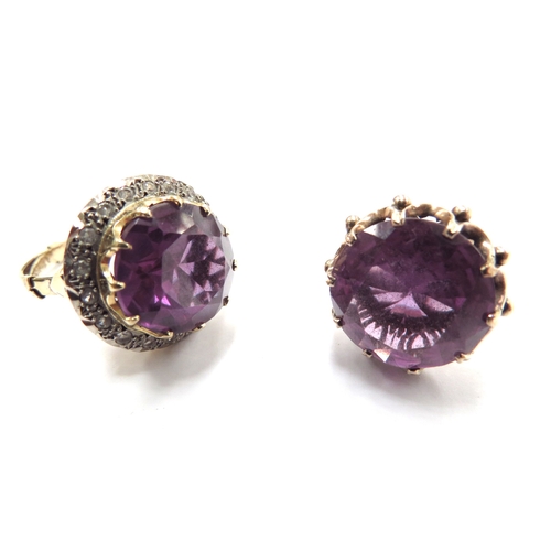 6070 - Two unmarked gold dress rings, both with a large amethyst coloured stone one framed by clear stones,... 