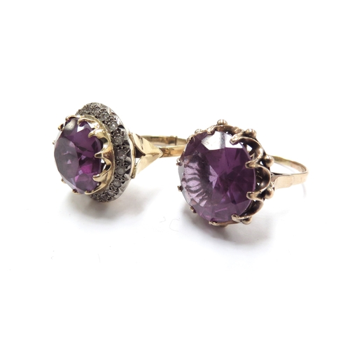 6070 - Two unmarked gold dress rings, both with a large amethyst coloured stone one framed by clear stones,... 