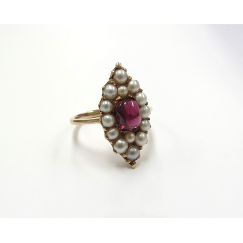 6399 - A marquise shape ring centrally set with a garnet cabochon framed by pearls, stamped 18ct. Size Q, 5... 