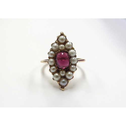 6399 - A marquise shape ring centrally set with a garnet cabochon framed by pearls, stamped 18ct. Size Q, 5... 