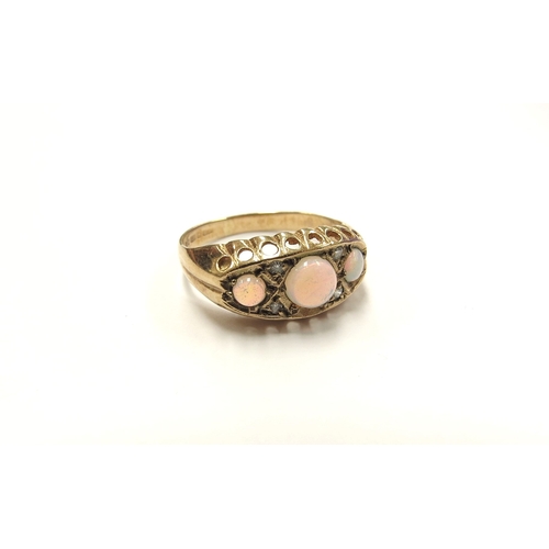 6369 - A 9ct gold opal and diamond chip ring, the three round opals spaced by diamond chips. Size I/J, 1.6g