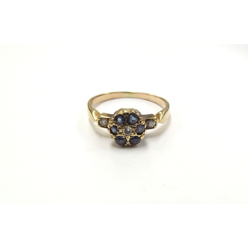 6396 - A sapphire and diamond circular cluster, flanked by diamonds, unmarked. Size L, 2.3g