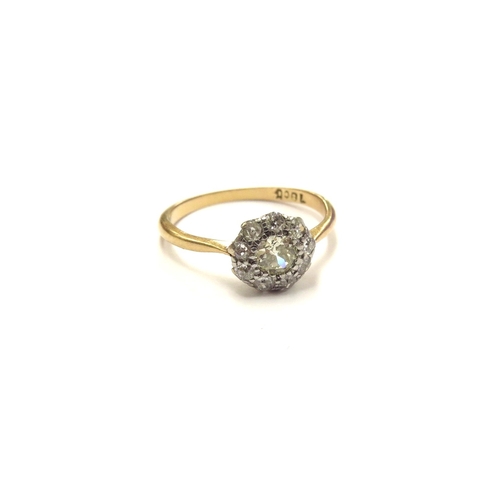 6031 - A diamond daisy cluster ring, stamped 18ct. Size P, 2.6g