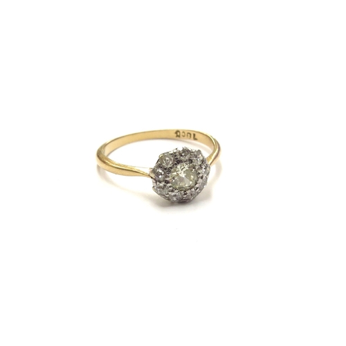 6031 - A diamond daisy cluster ring, stamped 18ct. Size P, 2.6g