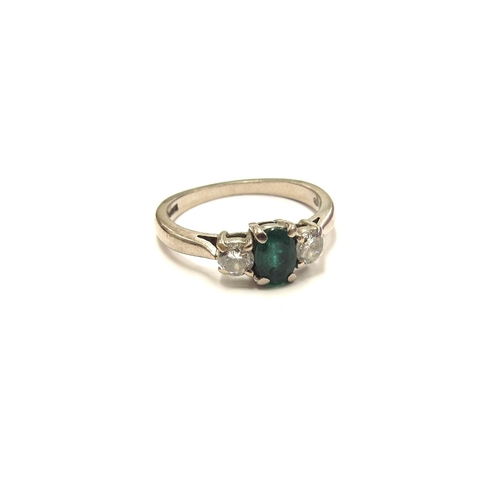 6015 - An 18ct white gold emerald and diamond three stone ring. Size K/L, 3.3g