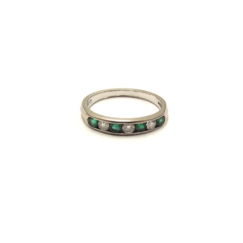 6016 - An 18ct white gold emerald and diamond half eternity ring in channel setting. Size M, 2.7g