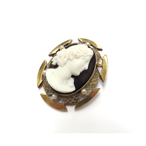 6091 - A cameo brooch with high relief of female pearl studded frame, unmarked gold, 33.6g total