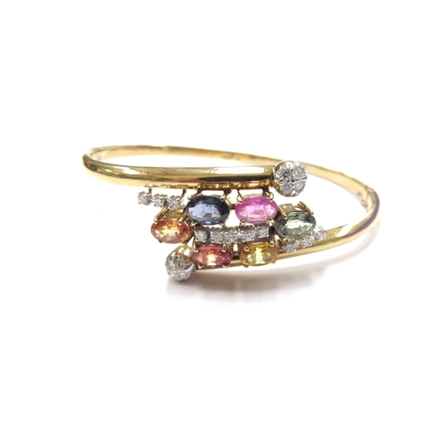 6022 - A 14ct gold hinged bangle set with multi-coloured sapphires and diamonds, 14.2g, 5.5cm x 4.5cm