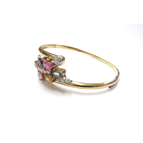 6022 - A 14ct gold hinged bangle set with multi-coloured sapphires and diamonds, 14.2g, 5.5cm x 4.5cm