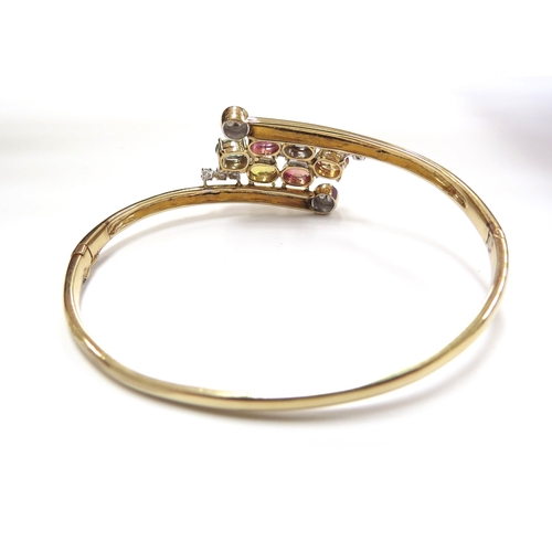 6022 - A 14ct gold hinged bangle set with multi-coloured sapphires and diamonds, 14.2g, 5.5cm x 4.5cm