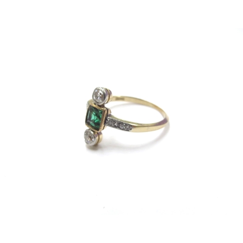 6298 - A diamond and green stone ring, the square centre stone set with a diamond to top and bottom with di... 