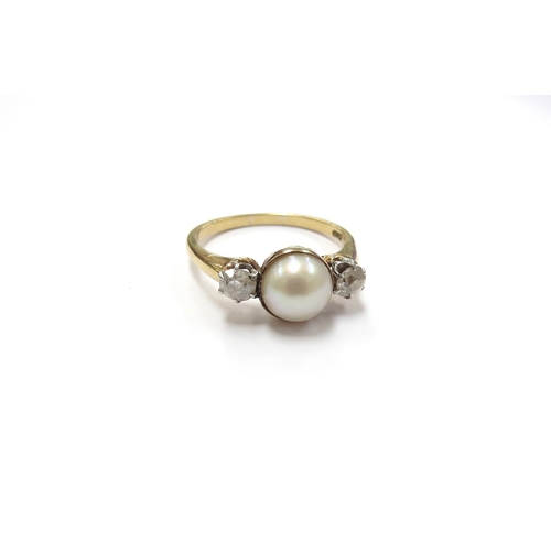 6036 - A gold ring centrally set with a pearl flanked by old cut diamonds, stamped 18ct. Size P, 3.5g