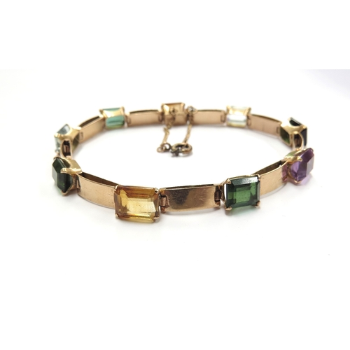 6056 - A gold bracelet set with multi-coloured gems, 18cm long, unmarked, 11.7g