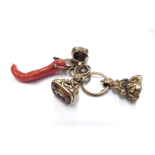 6035 - A coral pendant on a snake jump ring with watch key and three intaglio fobs, all unmarked