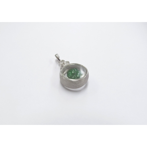 6049 - An 18ct white gold pendant with a jade Ram/Goat to centre glass panel, and three round cut diamonds,... 