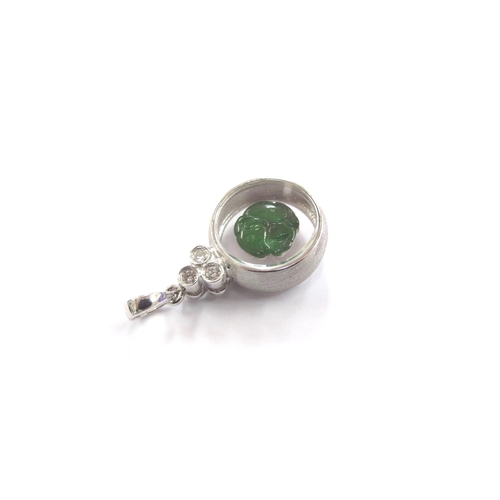 6049 - An 18ct white gold pendant with a jade Ram/Goat to centre glass panel, and three round cut diamonds,... 