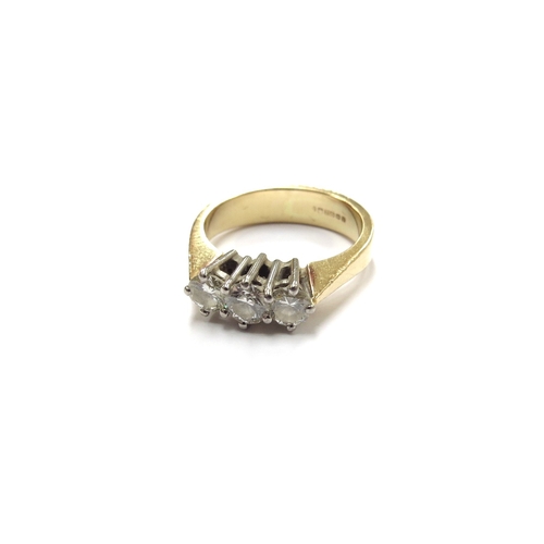 6009 - An 18ct gold three stone diamond ring 0.85ct total approx. Size P, 6.4g