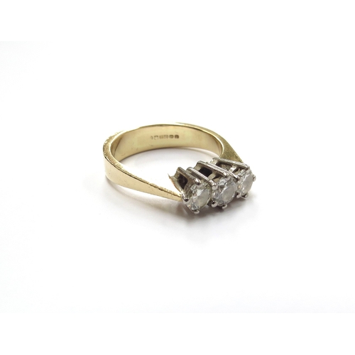 6009 - An 18ct gold three stone diamond ring 0.85ct total approx. Size P, 6.4g