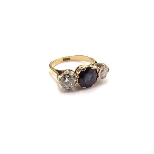 6007 - A sapphire and diamond three stone ring, the central round sapphire (worn to top) flanked by 0.25ct ... 